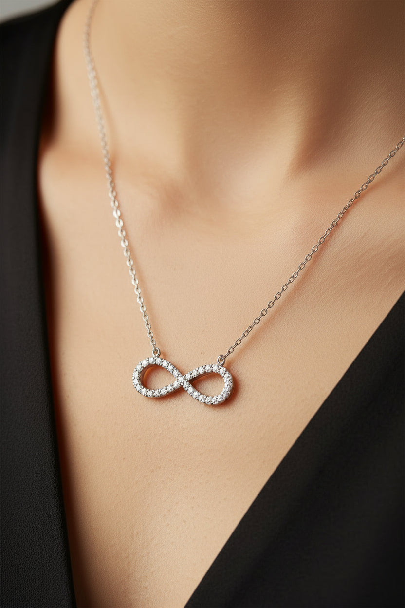 Silver infinity necklace on a white background