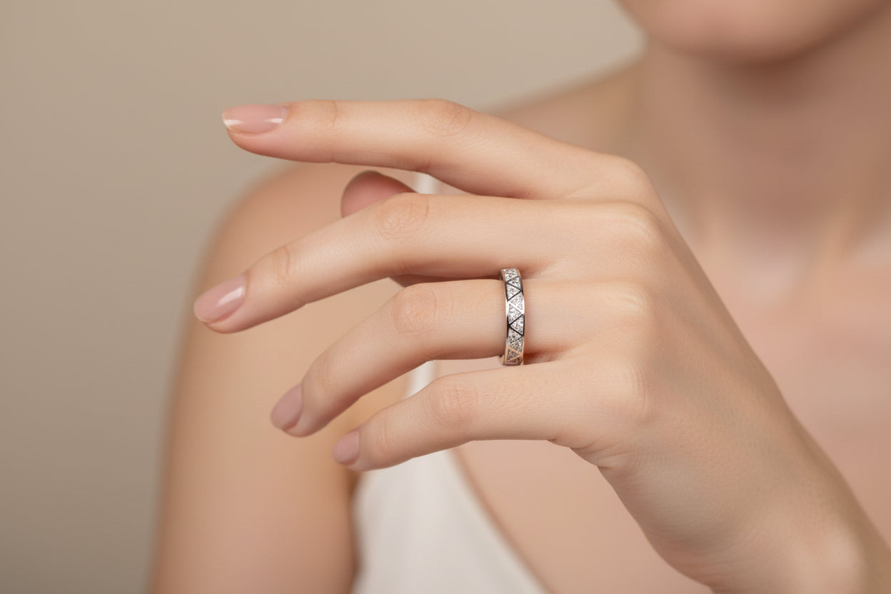 Silver ring with a diamond on green fabric