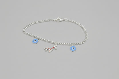 Silver bracelet with charms on a dark textured background