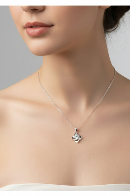 Silver necklace with a pendant on a wooden surface